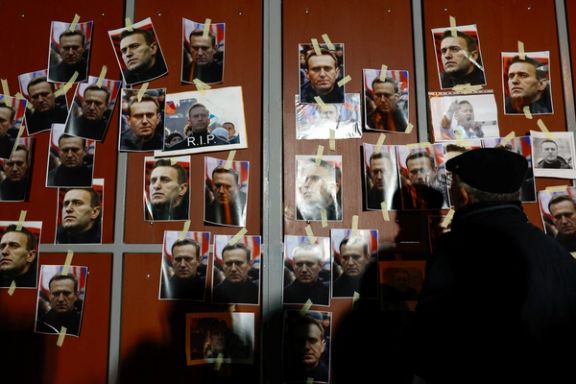 A man watches portraits of Russian opposition leader Alexei Navalny at the Russian embassy as people attend a protest and vigil held following the death of Navalny, in Kappara, Malta, February 19, 2024.