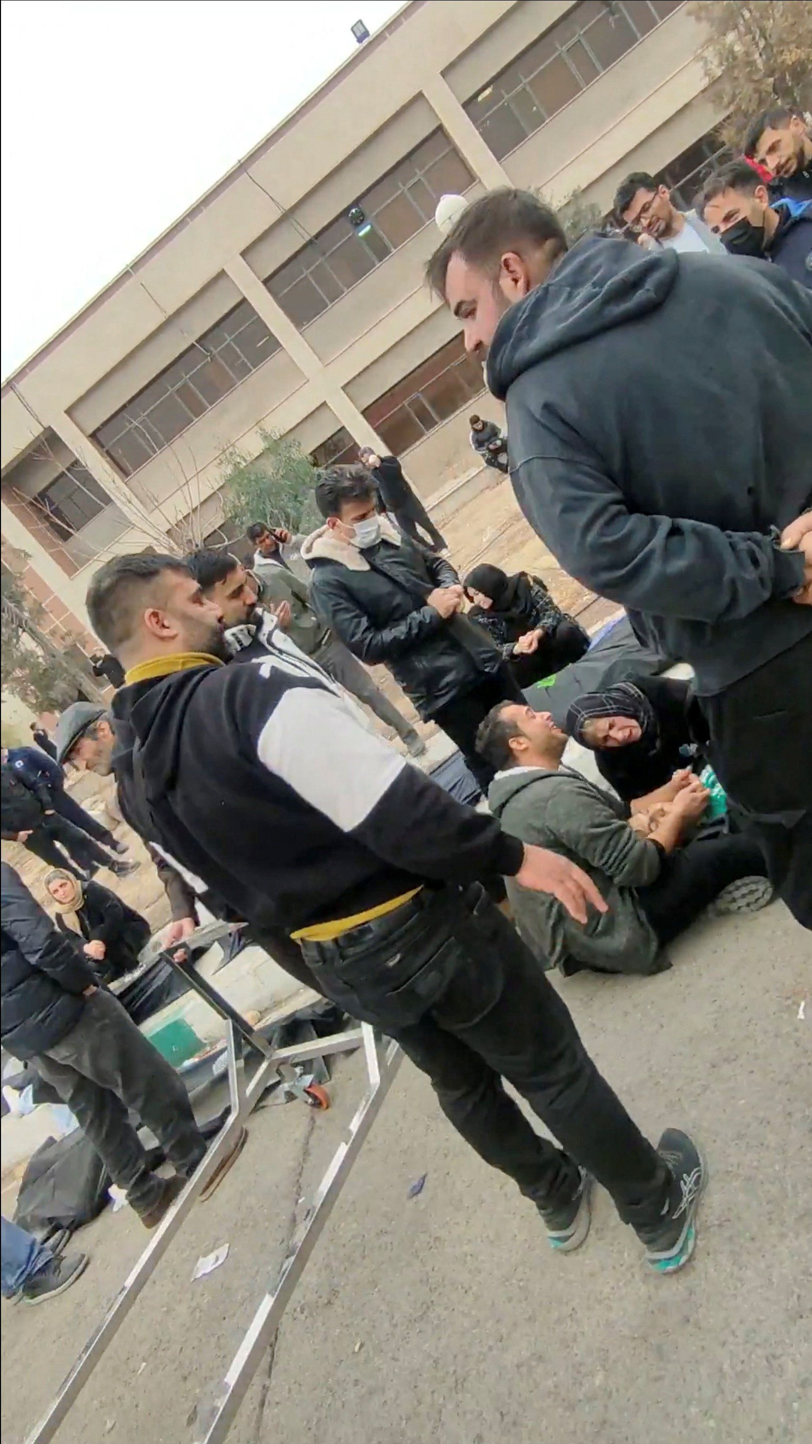 Families mourn as they gather at a facility to collect the bodies of loved ones killed during protests. (January 2026)