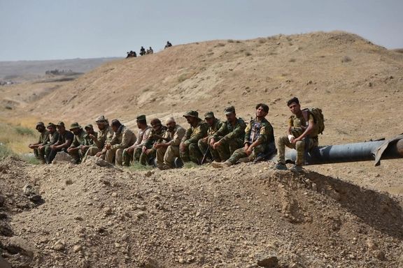 Shi'ite Popular Mobilization Forces (PMF) and Iraqi army members gather outside of Hawija, Iraq, September 30, 2017.