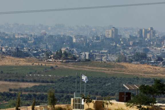 Israeli flag flutters in front of destroyed buildings in northern Gaza, amid the ongoing conflict between Israel and the Palestinian group Hamas, November 17, 2023.