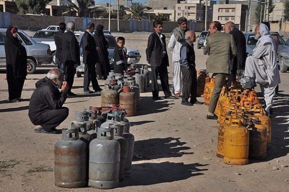 Iranians standing in line to refill their liquid petroleum gas cylinders